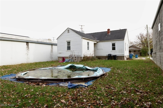 rear view of property with a lawn