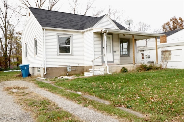 view of front of home with covered porch and a front yard