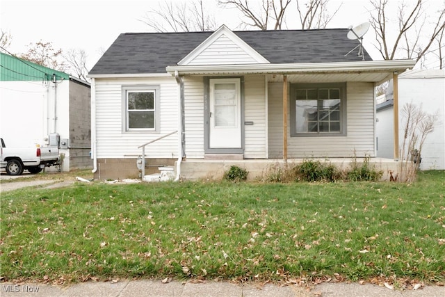 bungalow-style house with a front lawn and covered porch