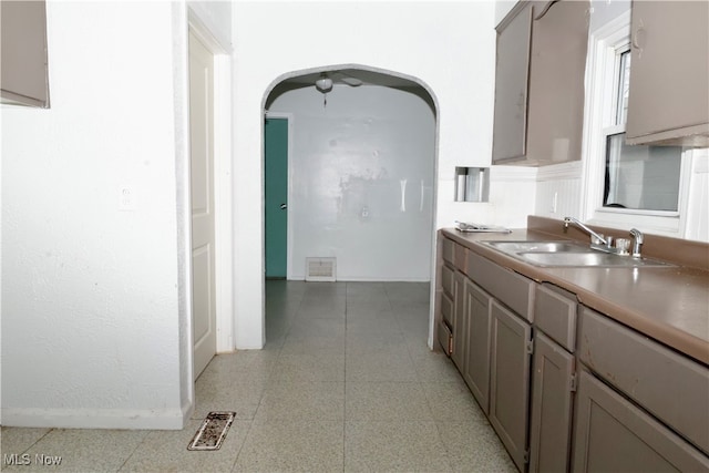 kitchen featuring gray cabinets and sink