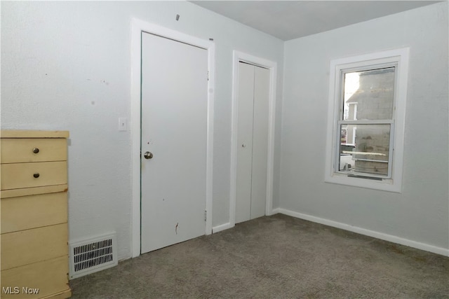 unfurnished bedroom featuring a closet and carpet