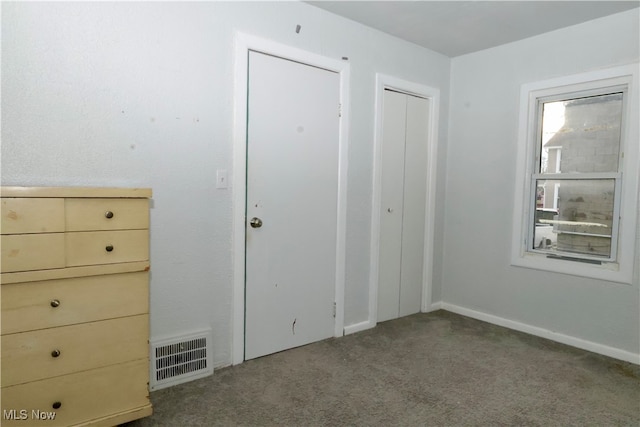 unfurnished bedroom with a closet and carpet floors