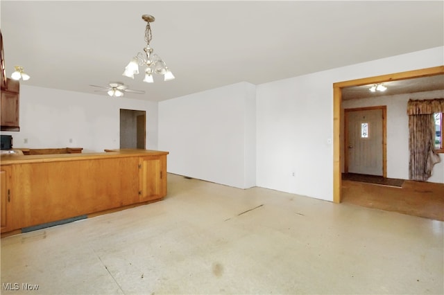 kitchen with pendant lighting and ceiling fan with notable chandelier