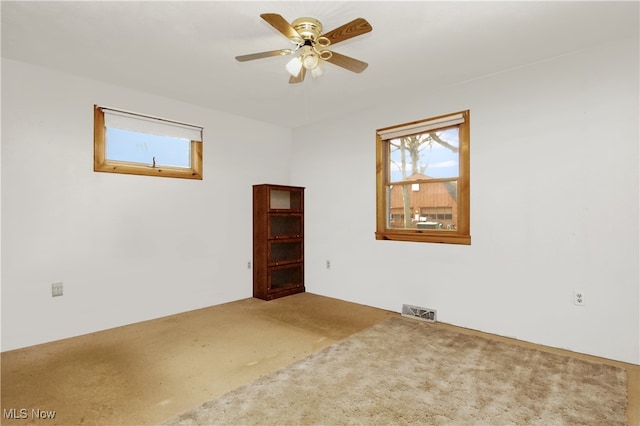 empty room featuring ceiling fan and carpet floors