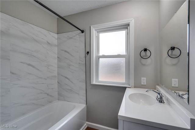 bathroom with vanity and tiled shower / bath