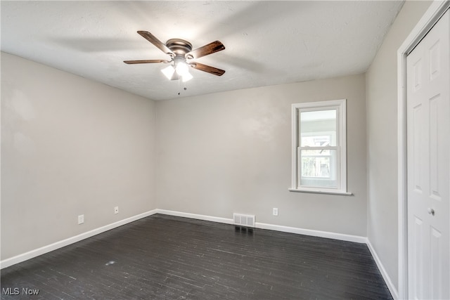 unfurnished bedroom featuring a closet, ceiling fan, dark hardwood / wood-style floors, and a textured ceiling