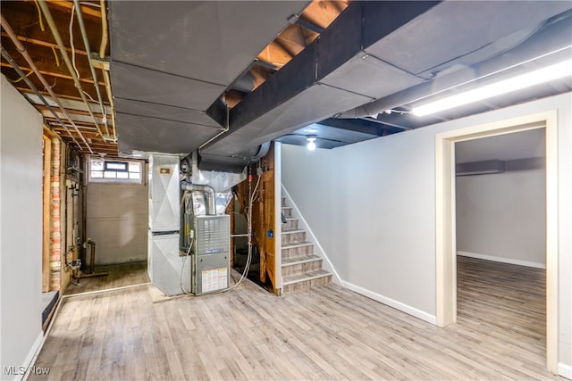 basement with heating unit and wood-type flooring