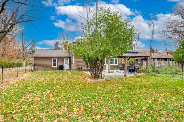 back of house featuring a gazebo and a yard