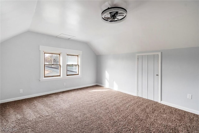 bonus room with lofted ceiling and carpet floors