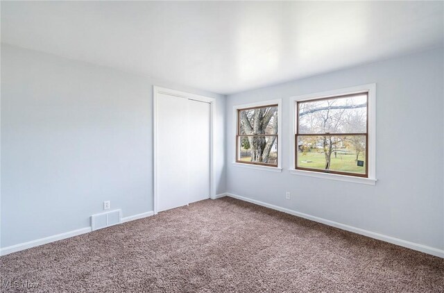 unfurnished room with carpet flooring