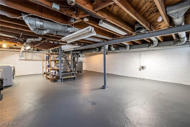 basement featuring washer / dryer and heating unit