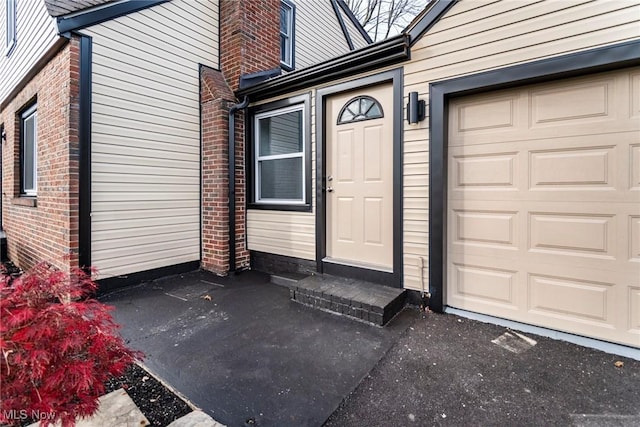 view of exterior entry featuring a garage