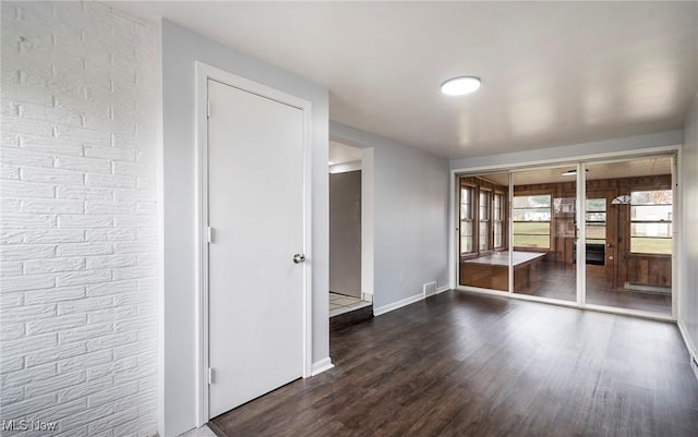 empty room with dark wood-type flooring