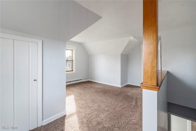 bonus room with lofted ceiling, a baseboard heating unit, and carpet flooring