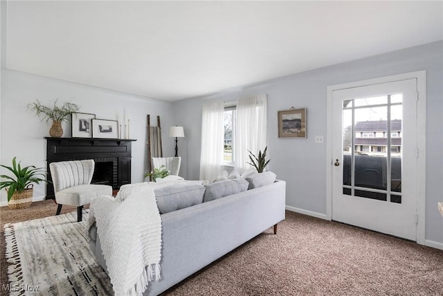 living room with carpet flooring and a fireplace