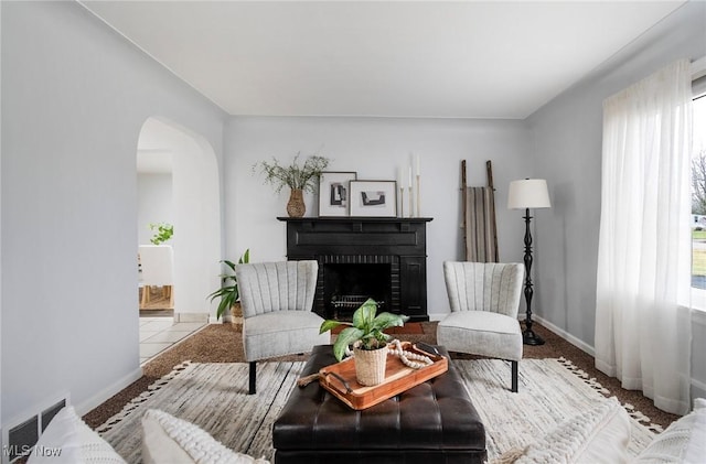 living area featuring a fireplace and light tile patterned flooring