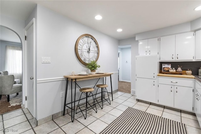 kitchen with white cabinetry and light tile patterned flooring