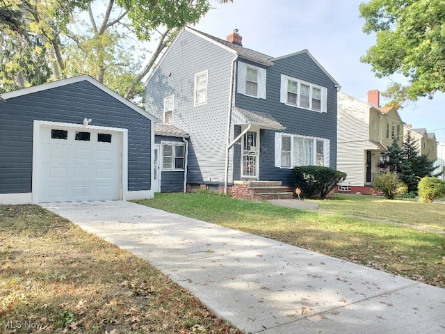 view of front property featuring a front yard and a garage