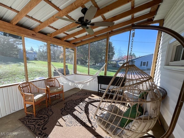 sunroom with vaulted ceiling with beams, ceiling fan, and a healthy amount of sunlight