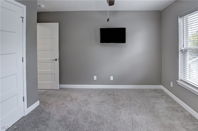 interior space with light carpet and ceiling fan