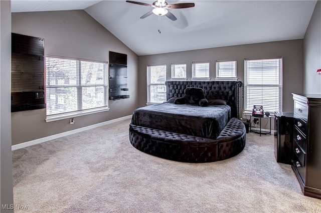 bedroom with vaulted ceiling, ceiling fan, multiple windows, and light carpet