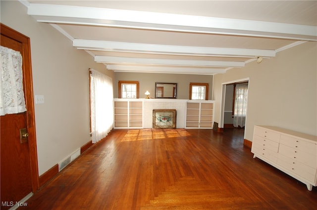 unfurnished living room featuring beam ceiling and dark hardwood / wood-style flooring