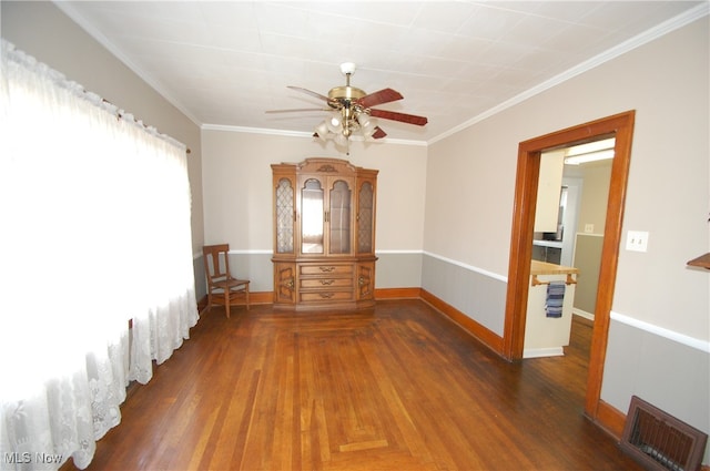 spare room with dark hardwood / wood-style floors, ceiling fan, and ornamental molding