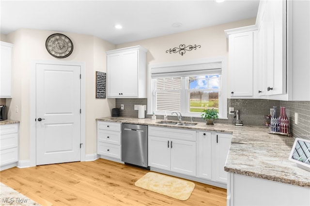 kitchen with white cabinetry, dishwasher, sink, and light hardwood / wood-style floors