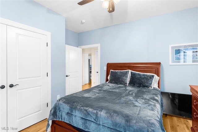 bedroom featuring a closet, ceiling fan, and light wood-type flooring