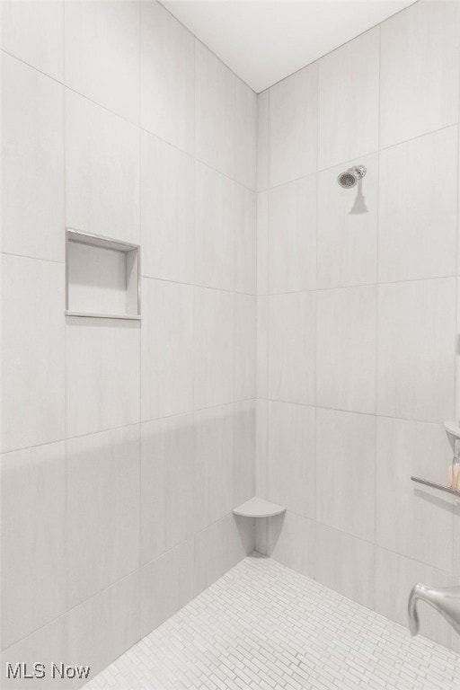 bathroom with a tile shower