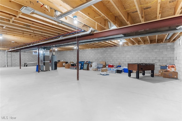 basement featuring water heater and heating unit