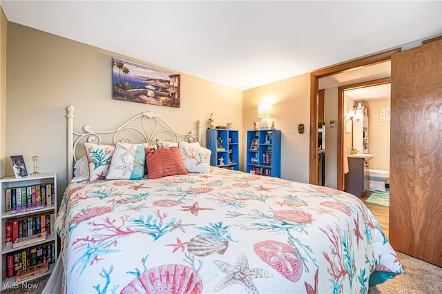 bedroom featuring connected bathroom and carpet