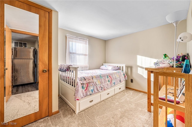 bedroom featuring light carpet and stainless steel refrigerator