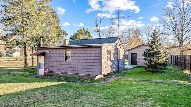 view of side of home with a yard