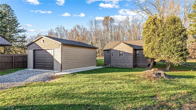 view of yard with a garage and an outdoor structure