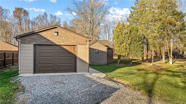 view of outbuilding with a yard and a garage