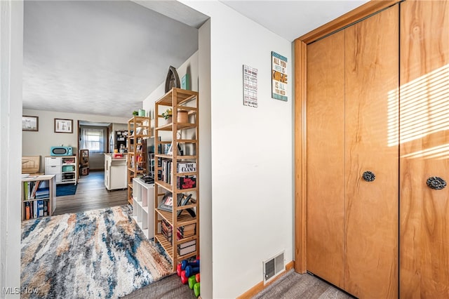 hallway with dark wood-type flooring