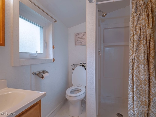 bathroom with vanity, vaulted ceiling, toilet, and walk in shower