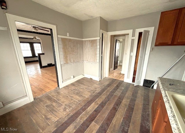 kitchen featuring a textured ceiling and light wood-type flooring