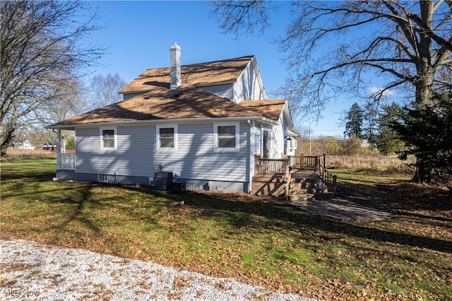 view of side of property featuring a yard and cooling unit