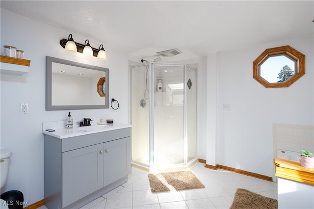 bathroom with vanity, tile patterned floors, and a shower with door