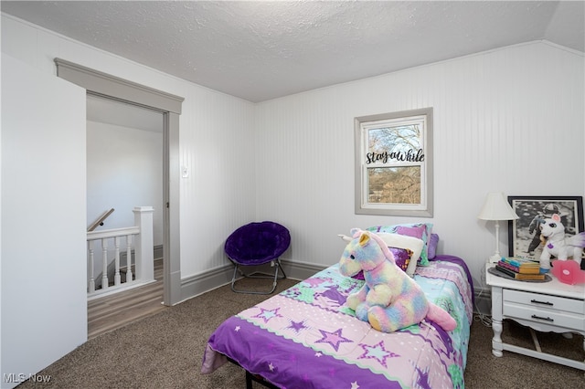 bedroom with a textured ceiling, dark carpet, and lofted ceiling