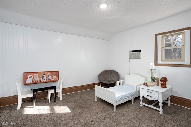 sitting room featuring dark colored carpet, a textured ceiling, a wall unit AC, and lofted ceiling