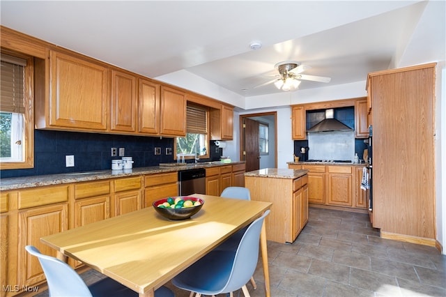 kitchen with dishwasher, a kitchen island, plenty of natural light, and wall chimney range hood