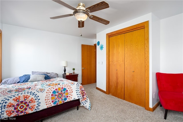 bedroom with ceiling fan, a closet, and carpet floors