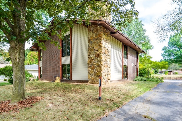 view of home's exterior with a lawn