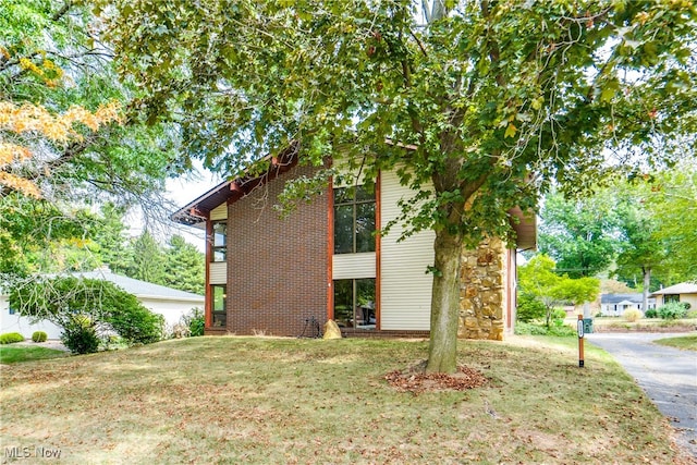 view of side of home featuring a lawn