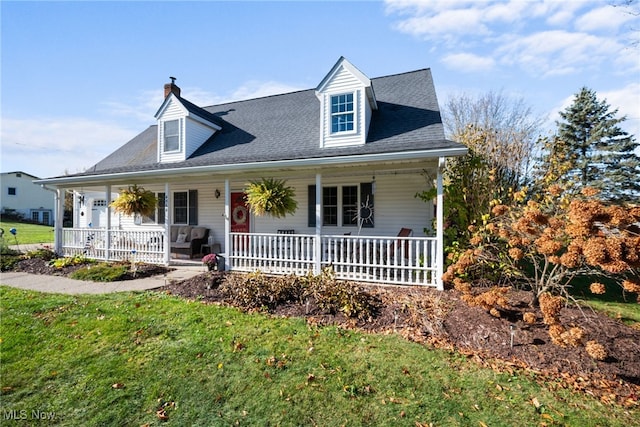 view of front of house with covered porch and a front lawn