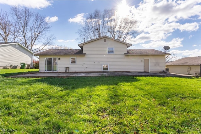 rear view of house featuring a patio area and a yard