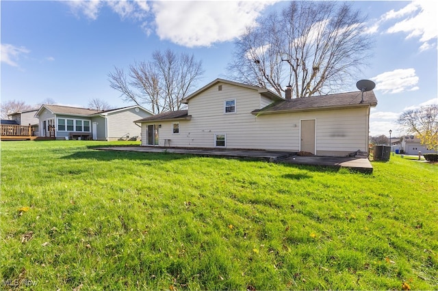 back of property featuring a lawn and a patio area